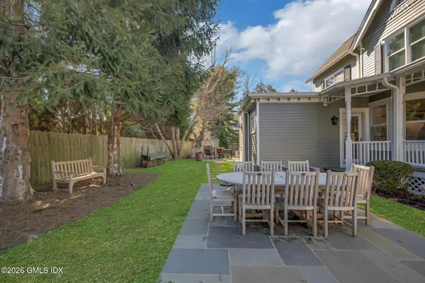 a view of a house with backyard sitting area and garden