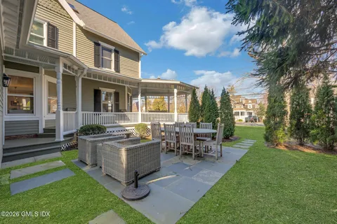 a front view of a house with a yard and trees