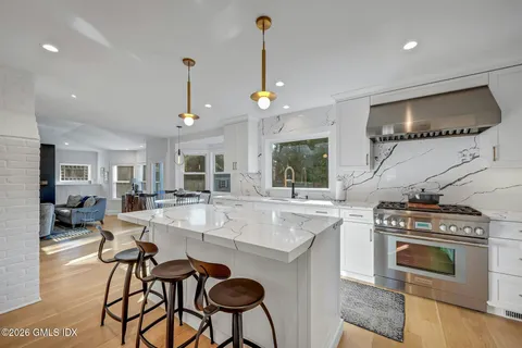 a view of living room with granite countertop furniture and a fireplace