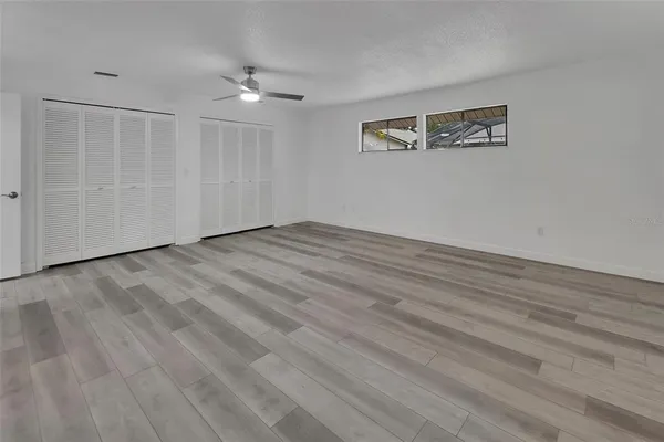 a view of an empty room with wooden floor