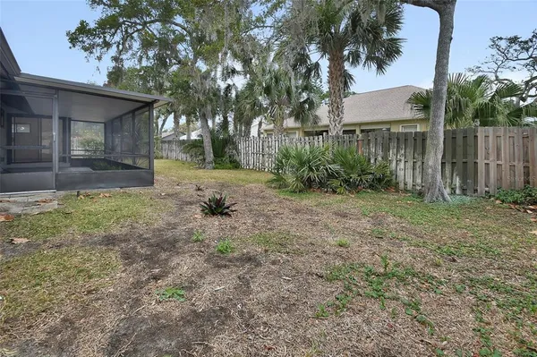 a view of a house with a yard and tree