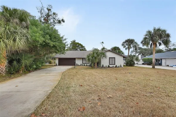 a front view of a house with a yard and a garage