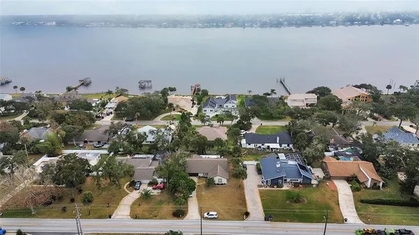 an aerial view of a house with a lake view