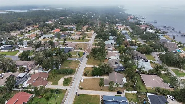an aerial view of residential houses with city view