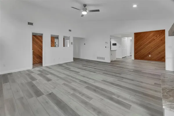 a view of empty room with wooden floor