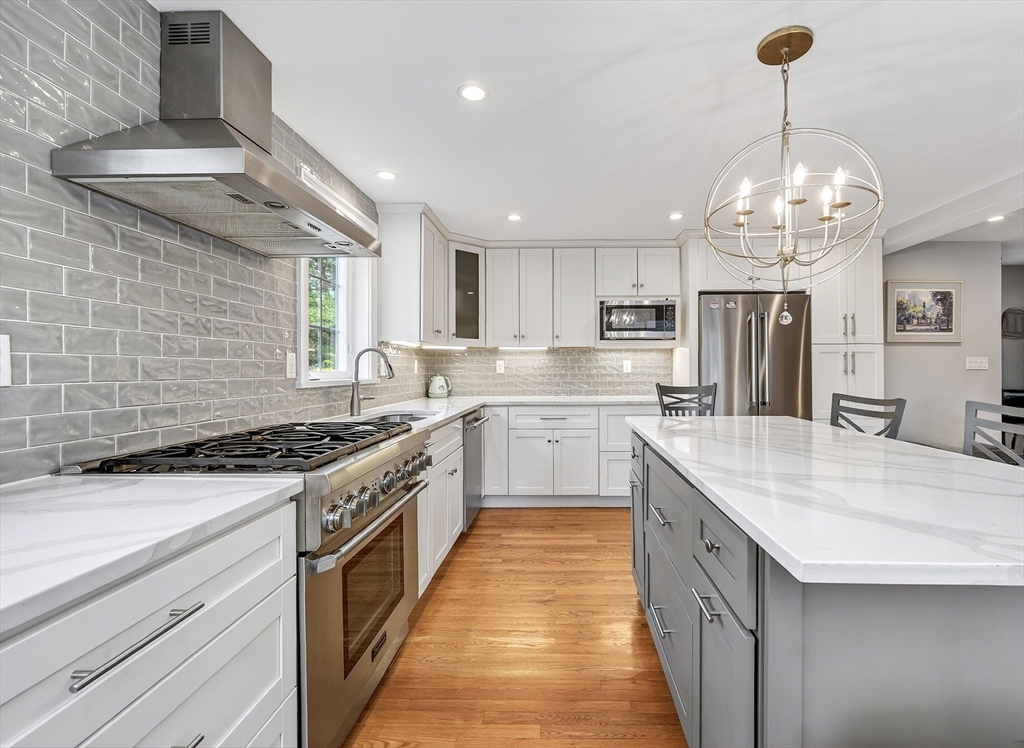 87 Payson Road Brookline, MA 02467 - Photo 15 of 41 a kitchen with stainless steel appliances granite countertop a sink a stove and a refrigerator