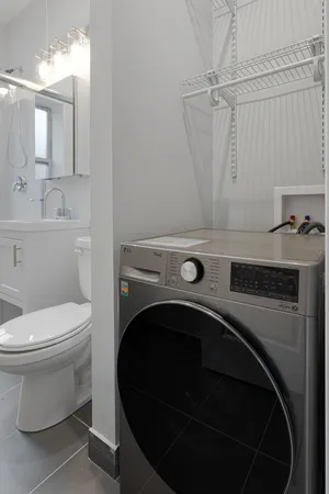 a bathroom with a shower a sink and mirror