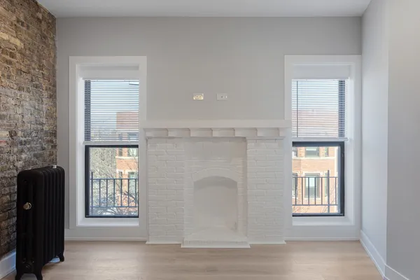 an empty room with windows and closet