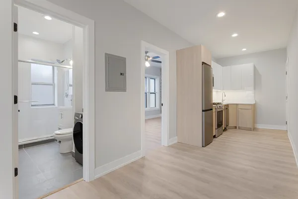 a view of a kitchen with a sink and a refrigerator