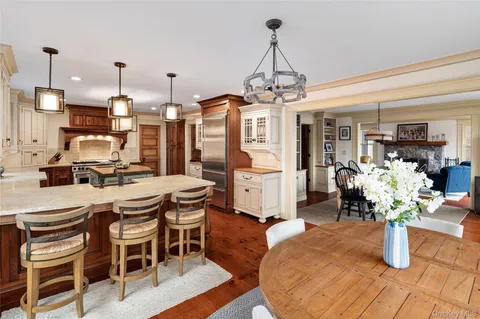 a dining room with furniture a chandelier and wooden floor