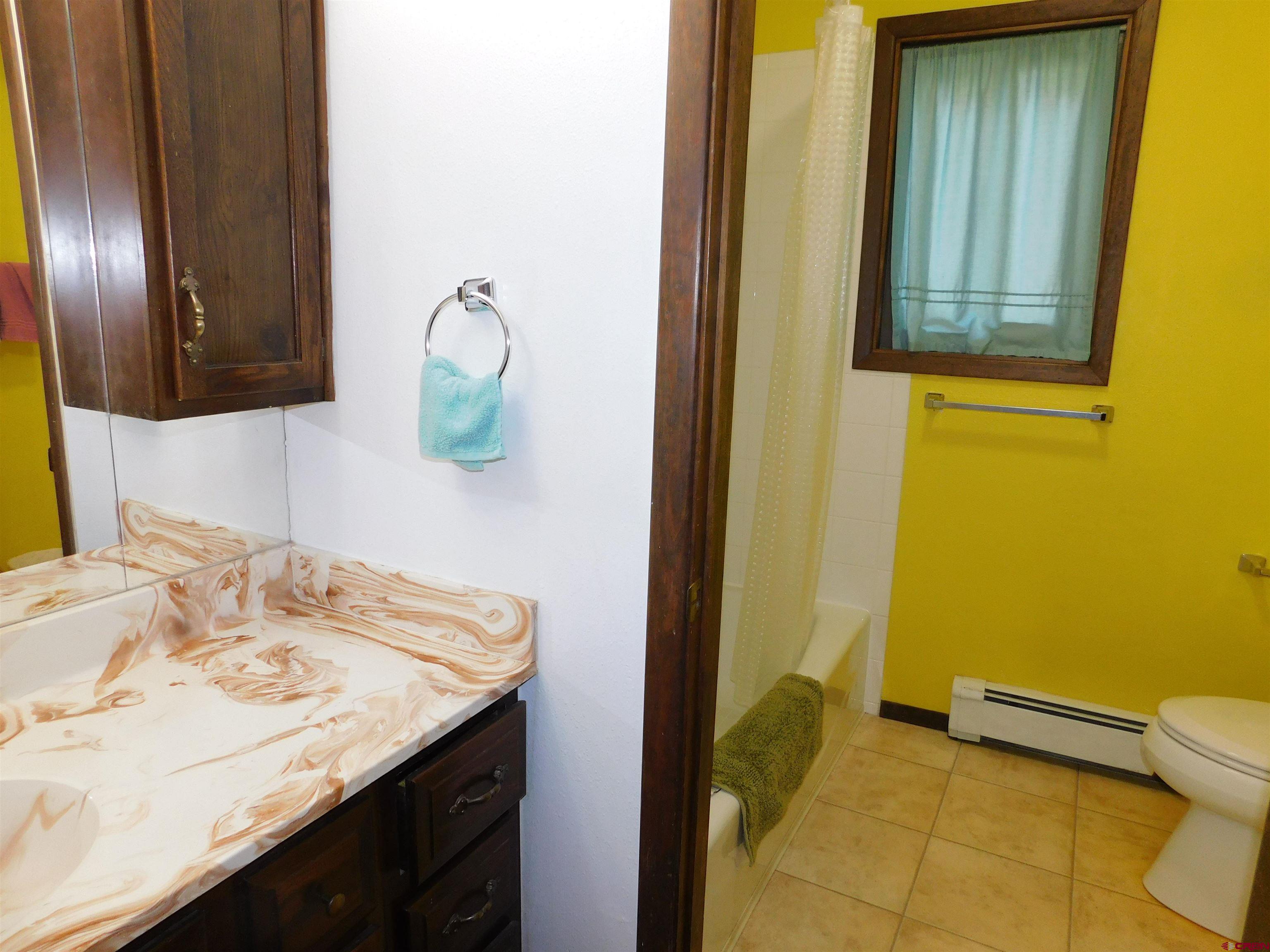19825 Rd P Cortez, CO 81321 - Photo 12 of 38 a bathroom with a granite countertop sink and a mirror