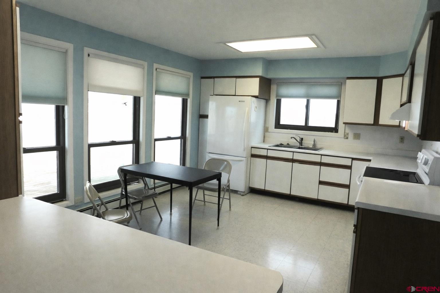 19825 Rd P Cortez, CO 81321 - Photo 5 of 38 a kitchen with stainless steel appliances granite countertop a sink a stove and a refrigerator