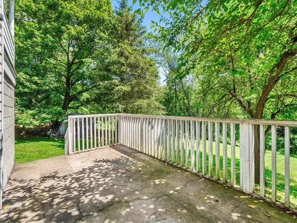 a view of a house with backyard and a chair