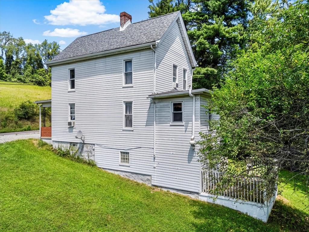 198 Penn Adamsburg Road Penn, PA 15675 - Photo 3 of 27 a front view of a house with a garden