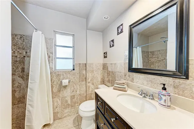 a bedroom with two beds and ceiling fan