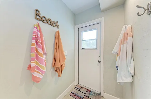 a bedroom with two bed and a lamp