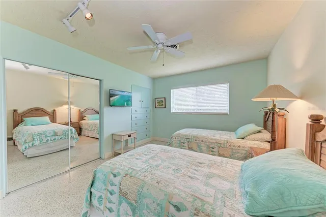 a bedroom with a large bed and a window