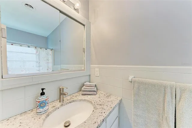 a view of a patio with a table and chairs and potted plants