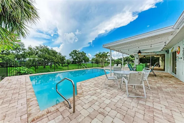 a view of a patio with a dining table and chairs