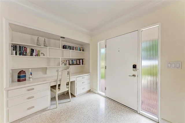 a living room with furniture a ceiling fan and a window