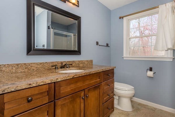 226 Daniels Street Franklin, MA 02038 - Photo 14 of 24 a bathroom with a toilet sink and mirror