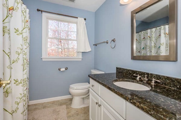 226 Daniels Street Franklin, MA 02038 - Photo 18 of 24 a bathroom with a granite countertop sink toilet and a mirror