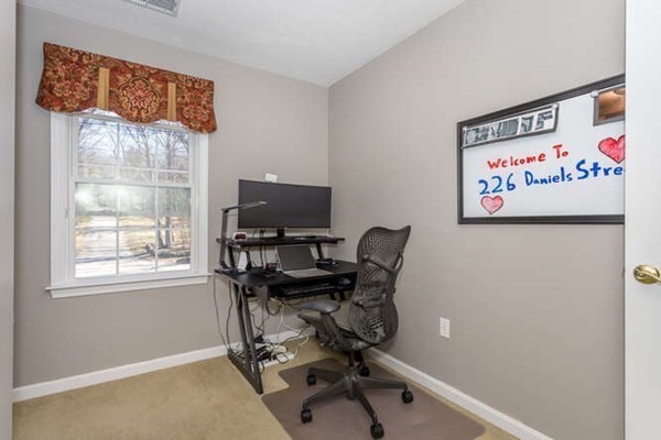 226 Daniels Street Franklin, MA 02038 - Photo 19 of 24 a view of a workspace with furniture and a window