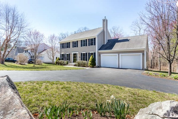226 Daniels Street Franklin, MA 02038 - Photo 2 of 24 a front view of a house with a yard and large tree