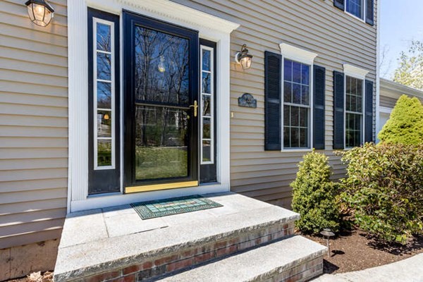 226 Daniels Street Franklin, MA 02038 - Photo 3 of 24 a front view of a house with a garden