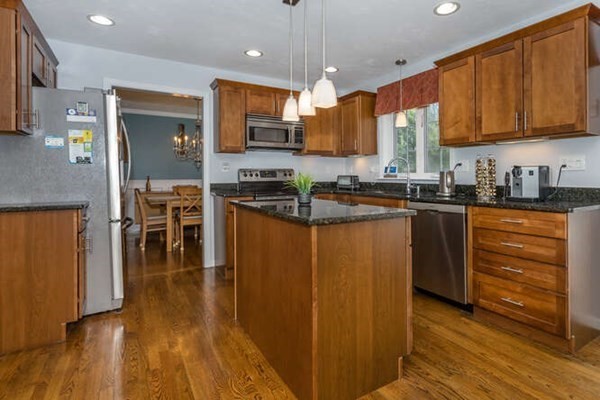 226 Daniels Street Franklin, MA 02038 - Photo 6 of 24 a kitchen with stainless steel appliances granite countertop wooden cabinets a refrigerator a stove a sink and a microwave