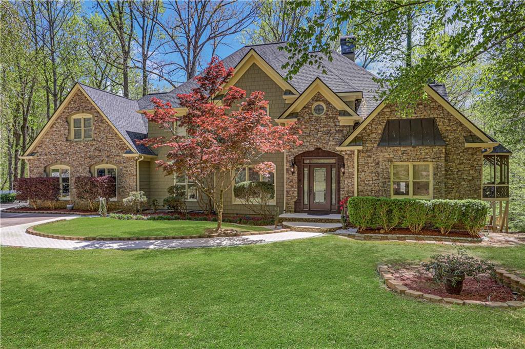 7355 Nicholson Road Cumming, GA 30028 - Photo 1 of 1 a front view of a house with a yard