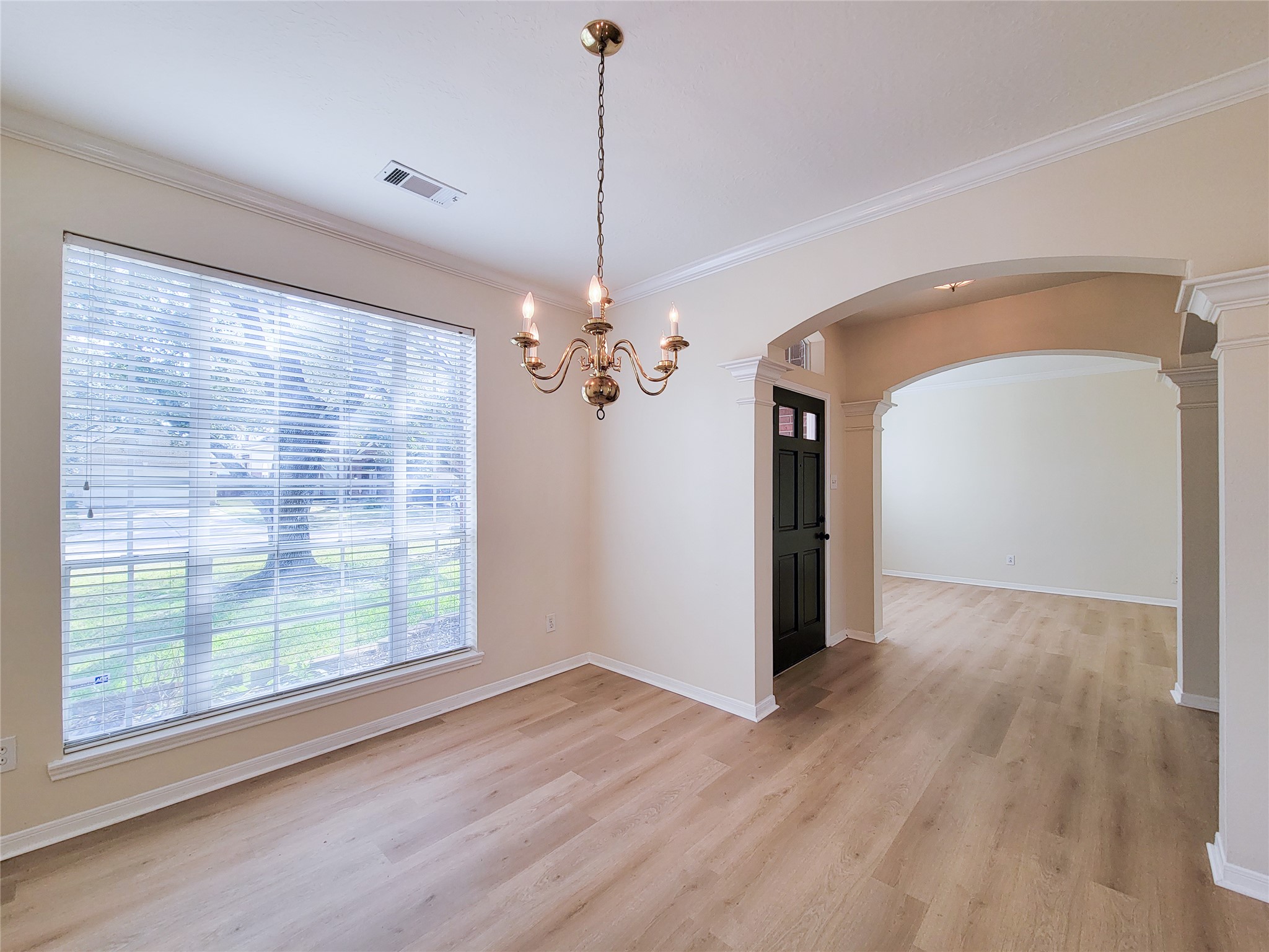 17314 Winfield Square Richmond, TX 77407 - Photo 11 of 47 a view of a room with wooden floor and chandelier