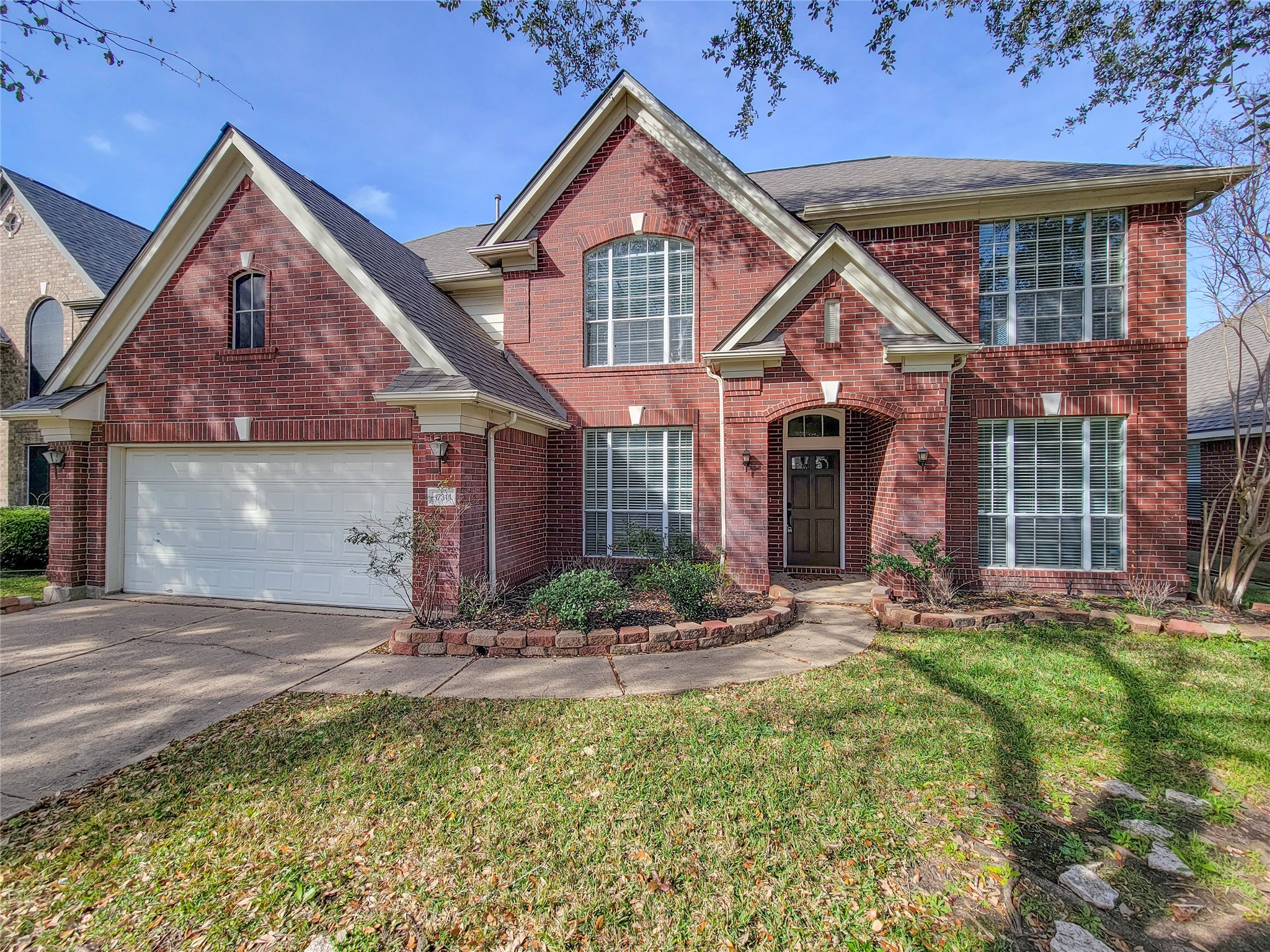 17314 Winfield Square Richmond, TX 77407 - Photo 2 of 47 a front view of a house with garden