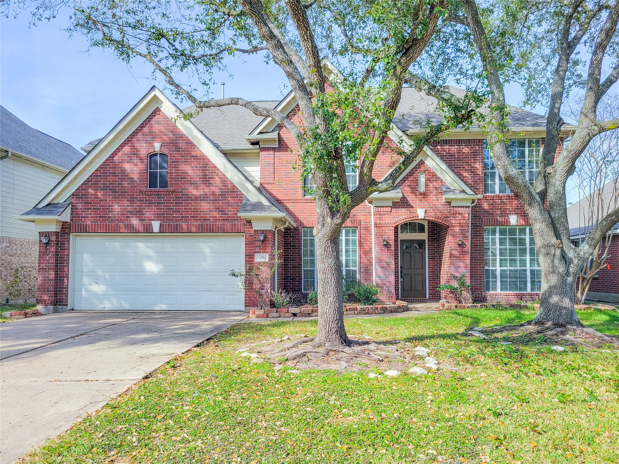 17314 Winfield Square Richmond, TX 77407 - Photo 3 of 47 a front view of a house with a yard and garage