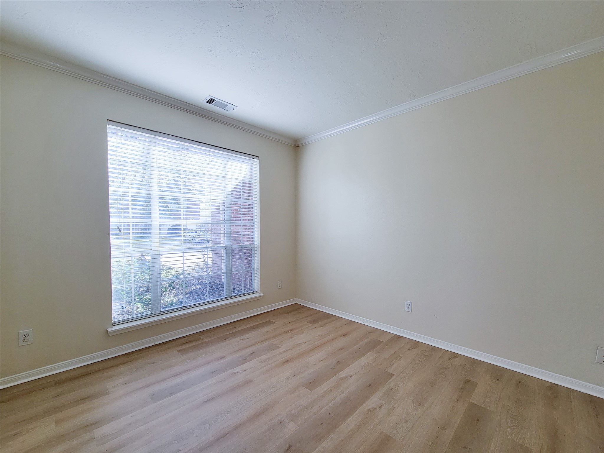 17314 Winfield Square Richmond, TX 77407 - Photo 6 of 47 an empty room with wooden floor and windows