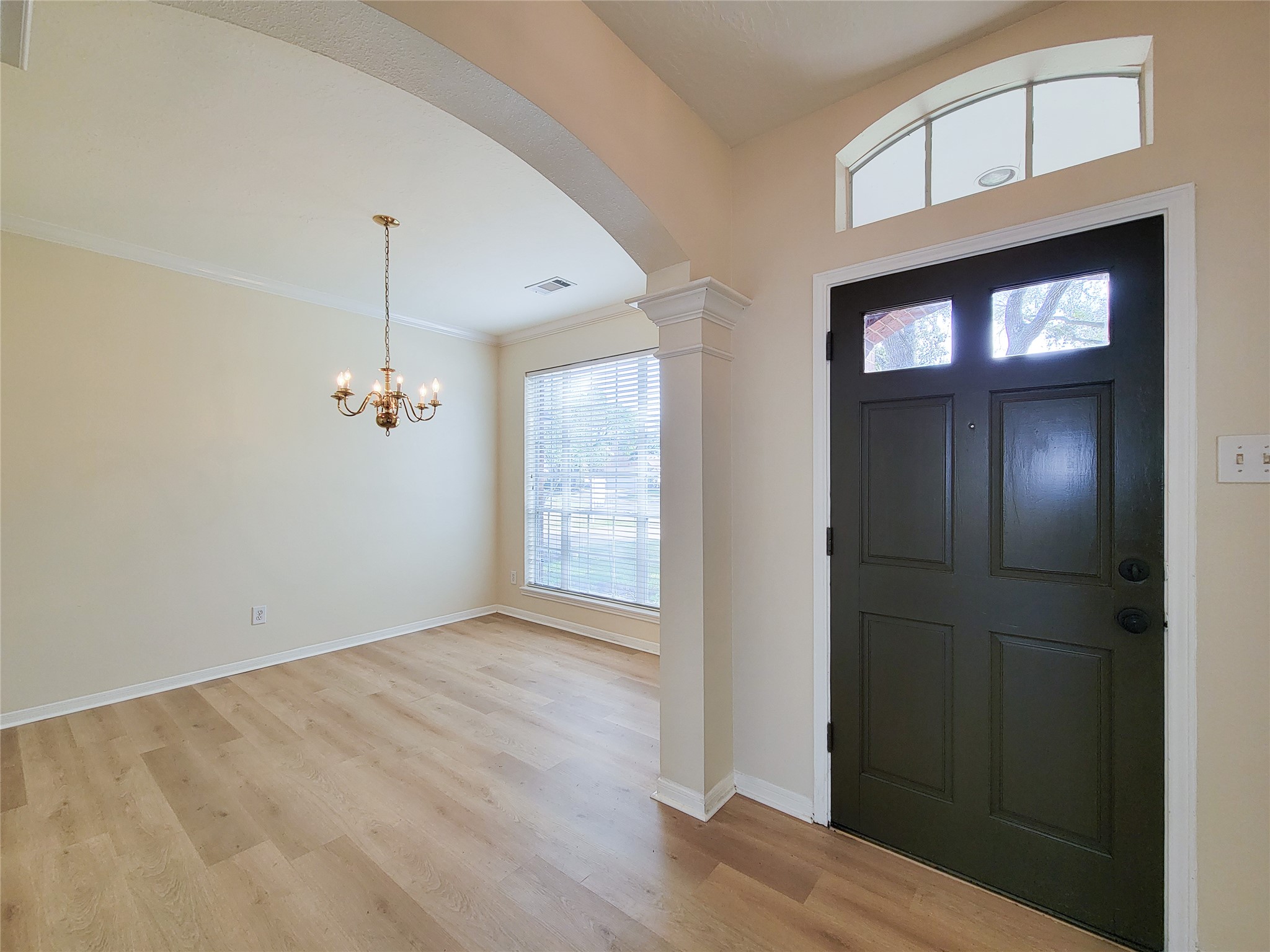 17314 Winfield Square Richmond, TX 77407 - Photo 9 of 47 an empty room with wooden floor mirror and windows