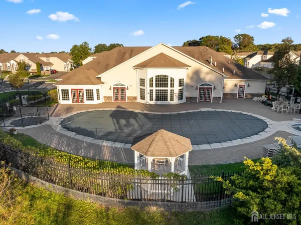 a view of a house with swimming pool and sitting area