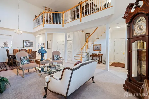 a living room with furniture a flat screen tv and a large window
