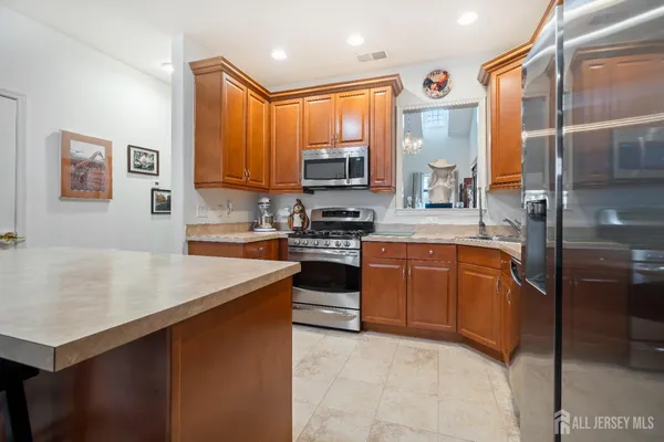 a kitchen with a refrigerator stove top oven and sink