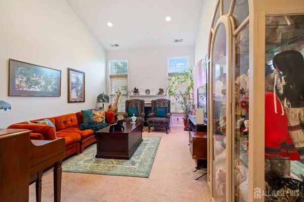 a living room with furniture and a large mirror