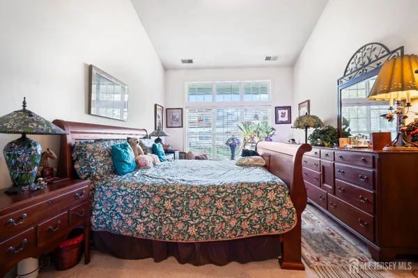 a bed room with a bed and a mirror