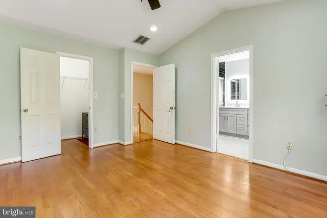 an empty room with wooden floor and closet