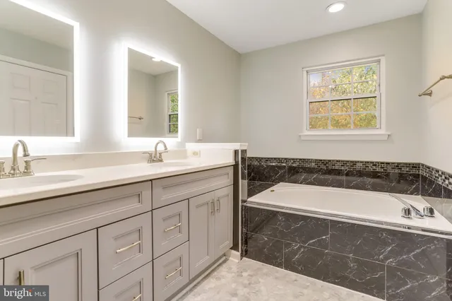 a bathroom with a bathtub and a sink