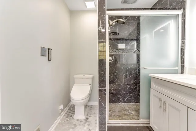a bathroom with a shower and a toilet