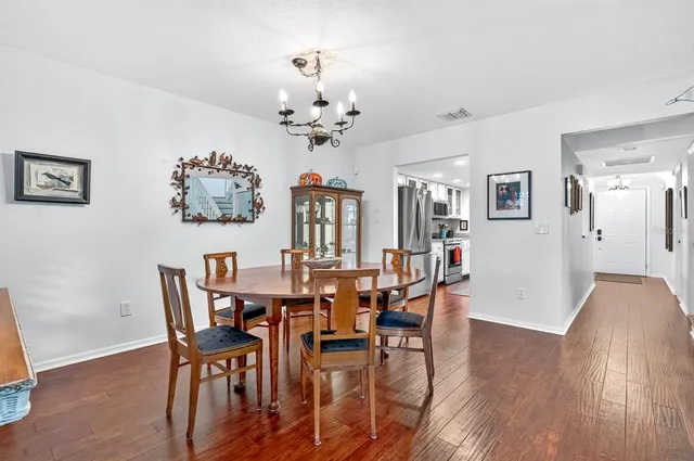 a view of a dining room with furniture and wooden floor