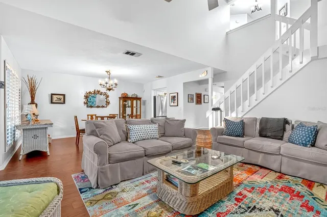 a living room with furniture a rug and a chandelier