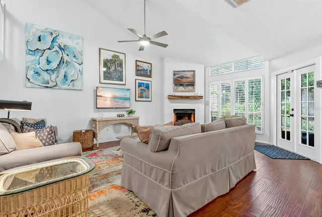 a living room with furniture fireplace and a window