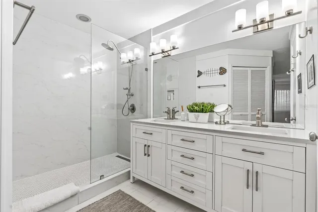 a bathroom with a shower sink and mirror
