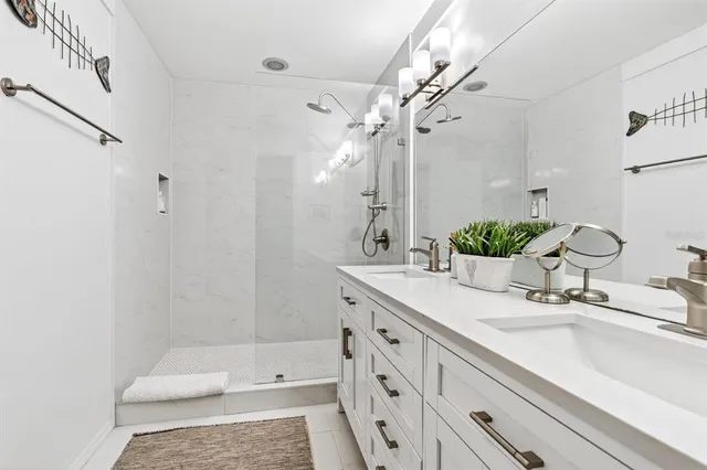 a bathroom with a tub sink and mirror