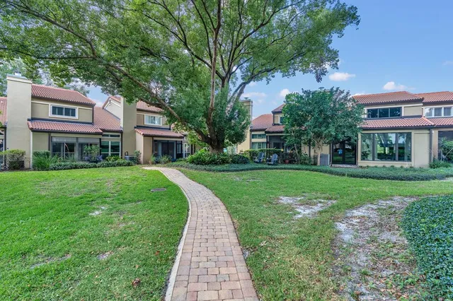 a front view of a building with a yard